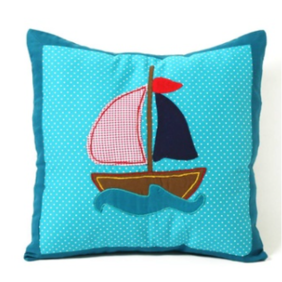 A cushion cover with a ship applique